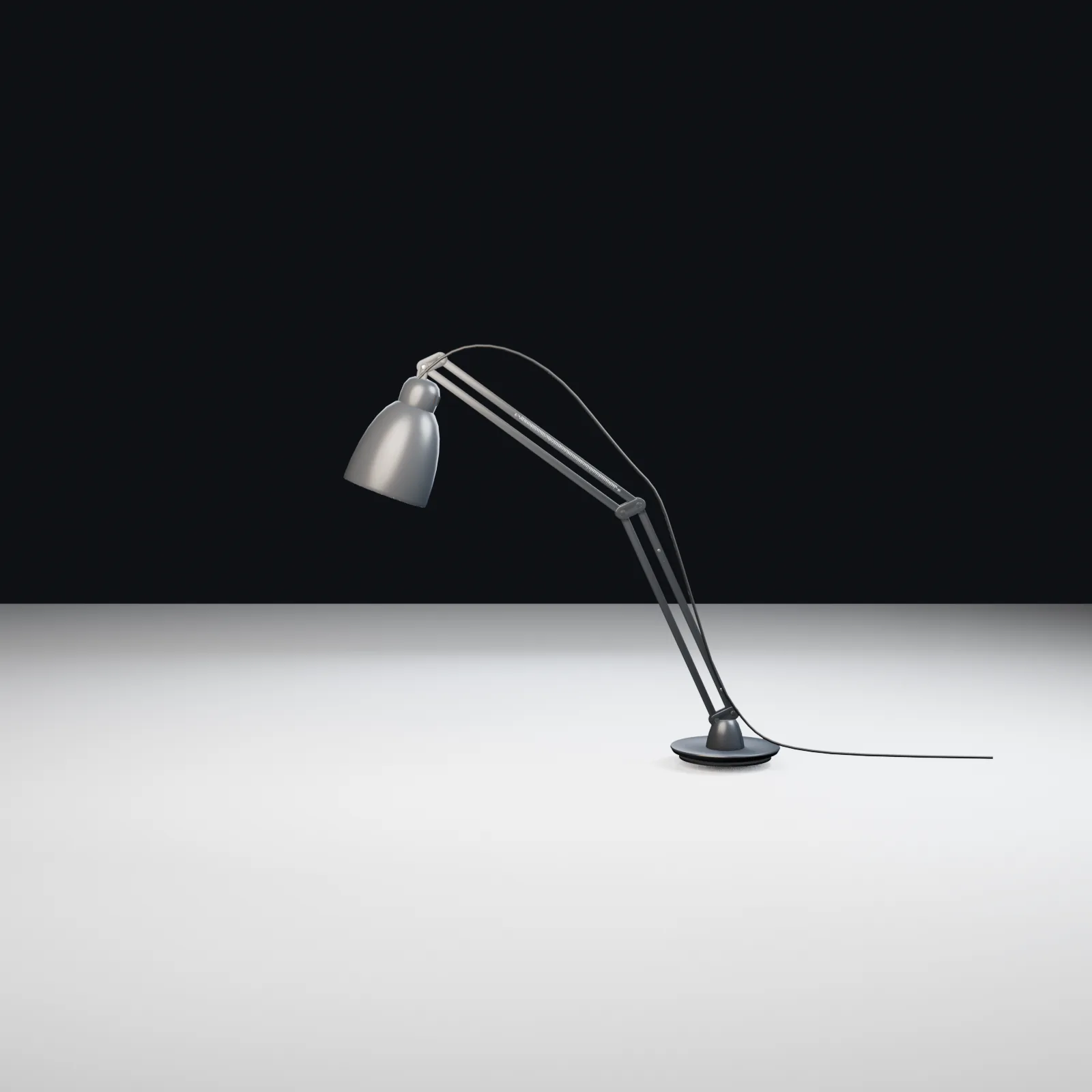 Accepted articulated Luxo L-1 task lamp with circular base, sprung arms, shade and power cable.